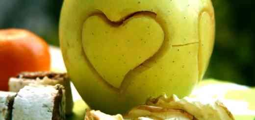 Curving a heart shape in green apple.